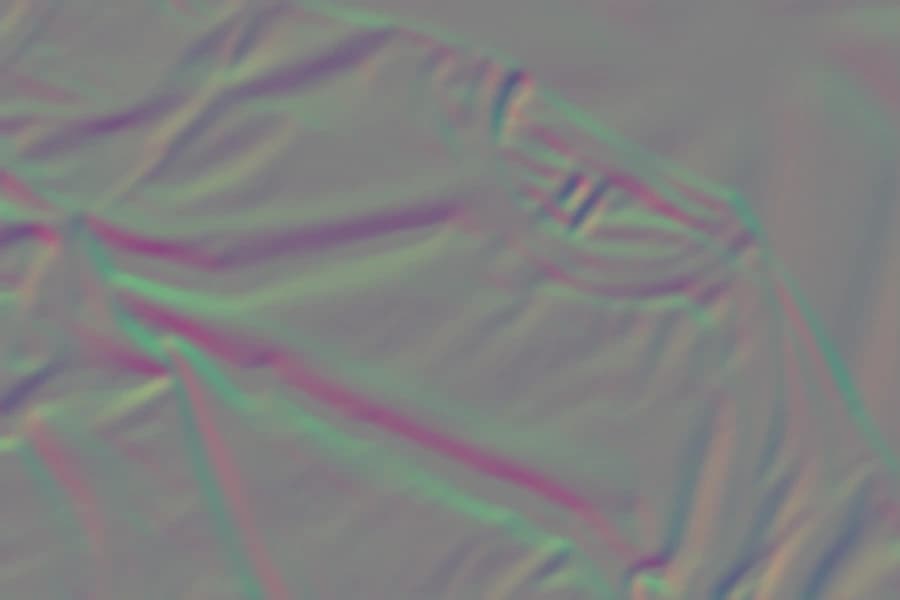 The displacement map derived from the tee photograph, showing folds and weave as colour