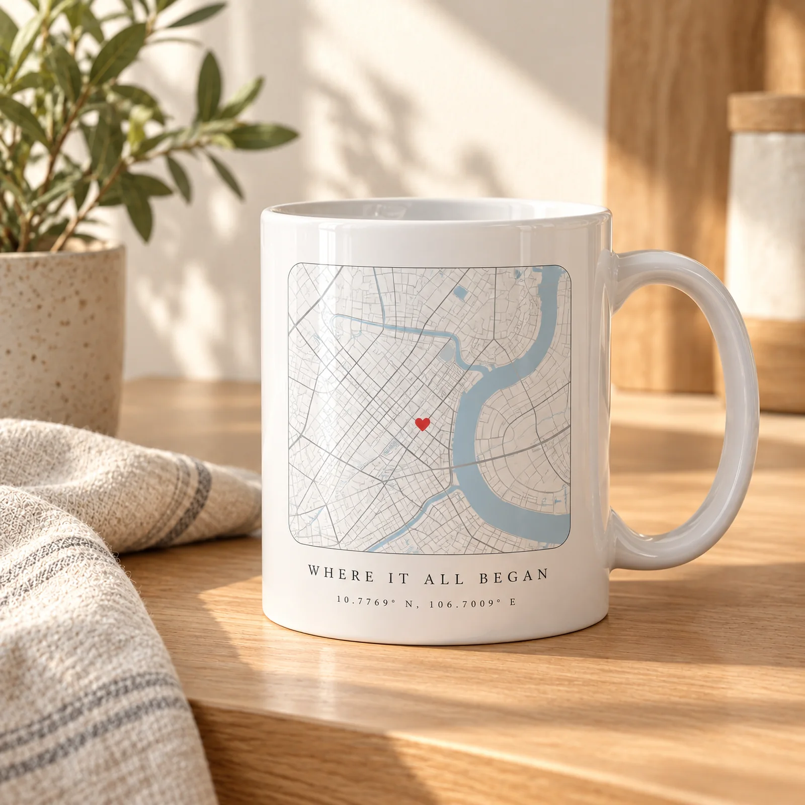 A white mug printed with a street map, a red heart pin and the words Where it all began